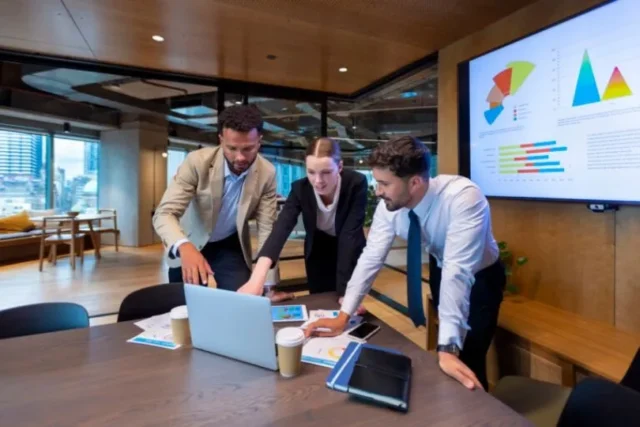 Business people working on a laptop computer in a modern office