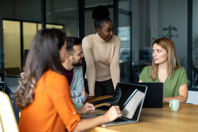 People gathered around a table discussing AI-driven internal mobility